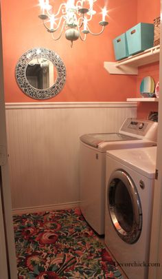 a washer and dryer in a room with a chandelier above it