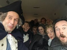 a group of people that are sitting in the back of a car together and making funny faces