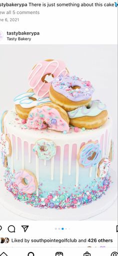 the cake is decorated with donuts and sprinkles on it's icing