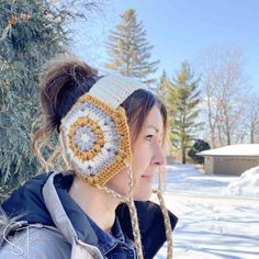 a woman wearing a crocheted hat in the snow