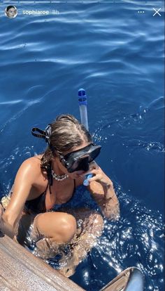 a woman is in the water with a snorkel