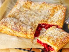 a close up of a pie on a cutting board with one slice missing from it