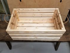 a wooden crate sitting on top of a table next to a piece of plywood