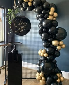 black, gold and white balloons are on display