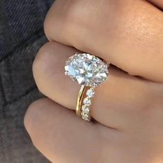 a woman's hand with a ring on it and a diamond in the middle