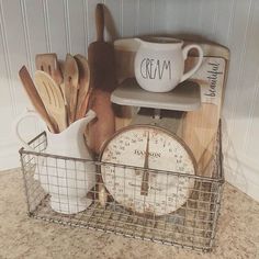 kitchen utensils and wooden spoons are in a wire basket on the counter