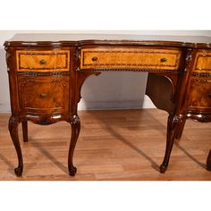 an antique wooden desk with two drawers on one side and a drawer on the other