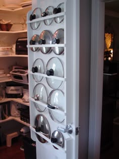 an open refrigerator door with plates and bowls on it