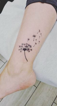 a small dandelion tattoo on the ankle