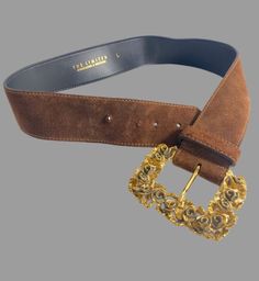 "Super sized and stunning, this 1 7/8\" wide suede belt was made in Italy with a bold gold tone floral sculpted buckle. Neutral mocha brown color easily coordinates with other colors. MEASUREMENTS BELT Width 1 7/8\" Length adjusts from 29 1/4 to 32\" BUCKLE Height 3 5/8\" Width 2 5/8\" Makes a thoughtful third anniversary gift (leather.) Label reads The Limited, genuine leather, made in Italy. In Very Good Vintage Condition. Some wear to materials consistent with age of belt. Shown with our 1960 Italy Birthday, Valentine Gifts Jewelry, Velvet Midi Skirt, Leather Anniversary Gift, Suede Belt, Rhinestone Bow, Vintage Belt, Mocha Brown, Leather Label