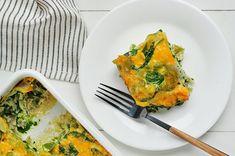 a white plate topped with a casserole covered in cheese and veggies