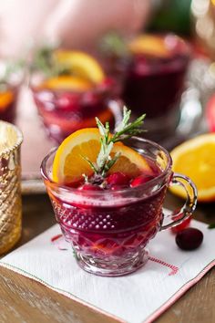 a glass cup filled with liquid and garnished with fruit