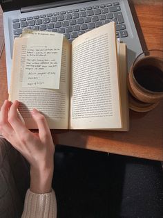 an open book sitting on top of a laptop computer