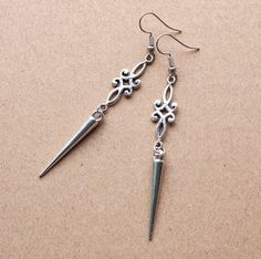 Embrace the warrior spirit with these Viking Spike Earrings, featuring antique silver charms and elongated spikes for a bold medieval allure. Key Features: Material: Antique silver charms and spikes Length: 3.2 inches with ear wire, 2.75 inches without Design: Intricately crafted to evoke a medieval aesthetic Make a statement with these distinctive earrings, perfect for those who seek to infuse their style with historical inspiration and feminine strength. To see more accessories please visit my Silver Jewelry Aesthetic Earrings, Vikings Accessories, Witch Earring, Medieval Earrings, Medieval Accessories, Nordic Jewelry, Feminine Strength, Fantasy Earrings, Medieval Aesthetic