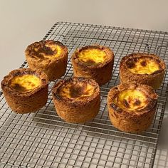 four muffins sitting on top of a cooling rack