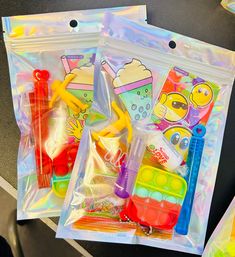 two clear bags filled with toys on top of a black table next to each other