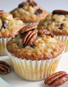 some pecans are sitting on a plate with muffins