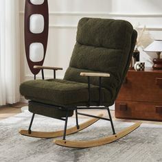 a rocking chair in a living room next to a lamp