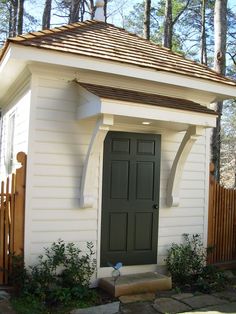 a small white house with a green door