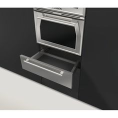 an oven with the door open in front of a black wall and white countertop