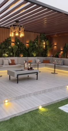 an outdoor living area with couches and lights