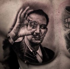 a man's chest with a portrait of the late show host and his hand on his face