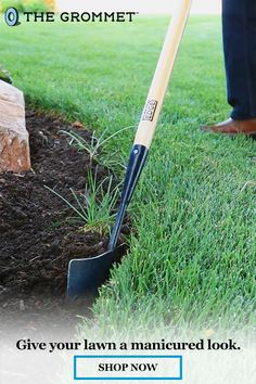 a person is digging in the grass with a shovel