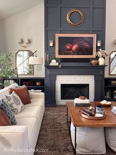 a living room filled with furniture and a fire place in front of a painting on the wall