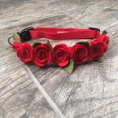 a red flowered headband with green leaves