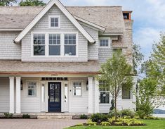 a large white house with two story windows on the front and side of the house