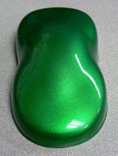 a shiny green object sitting on top of a table