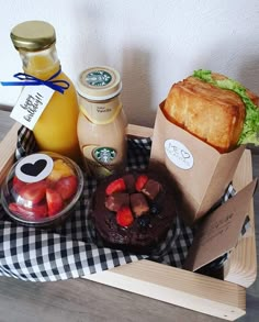 a basket filled with food and drinks on top of a table