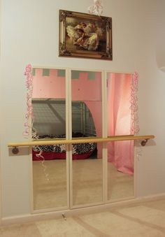 an image of a mirror in the middle of a room with pink curtains on it