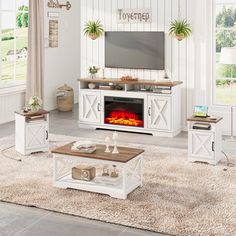 a living room filled with furniture and a flat screen tv mounted on a wall next to a fire place