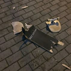 a broken street sign laying on the ground