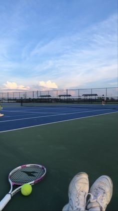 a tennis ball and racket are on the court