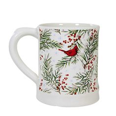 a white mug with a red bird on it and holly branches around the cup, which is decorated with berries