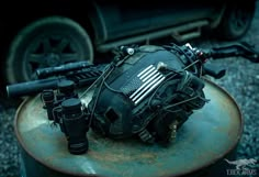 an old motorcycle engine with american flag painted on it's side and two binoculars