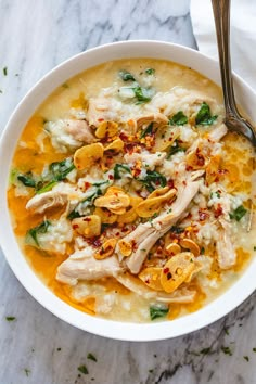 a white bowl filled with chicken and rice soup