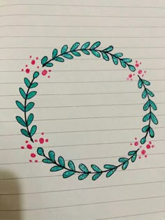 a drawing of a circle with leaves and berries on it, drawn in pencils