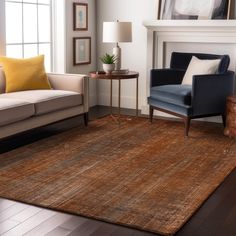 a living room area with couches, chairs and a rug on the floor in front of a fireplace