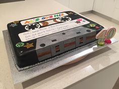 a cake made to look like an old school cassette tape recorder with writing on it