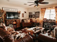 a living room filled with furniture and a flat screen tv mounted on the wall above a fireplace