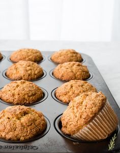 freshly baked muffins sitting in a muffin tin ready to be eaten on the counter