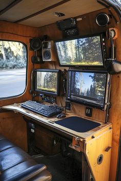 the inside of a vehicle with multiple monitors and keyboards