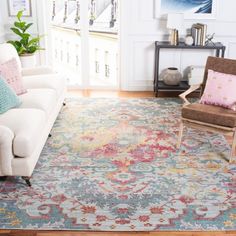 a living room filled with furniture and a rug