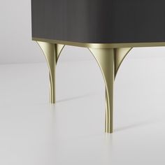 a black and gold table with two curved legs