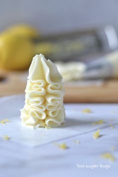 a lemon buttercream frosting recipe on a cutting board with the words easy lemon buttercream frosting