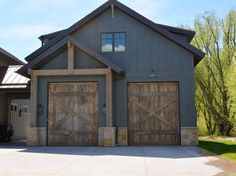 two garage doors are open in front of a house