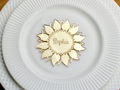 a white plate topped with a golden sunflower